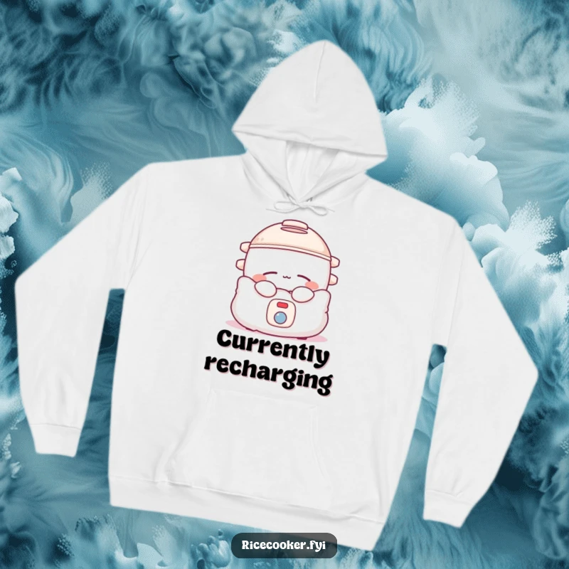 Funny rice cooker hoodie showing a sleepy appliance nestled in a pillow, promoting warmth and relaxation.